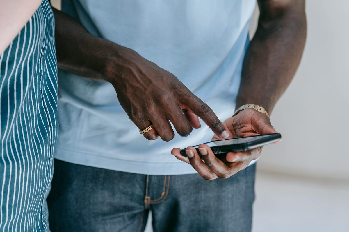 Close-up of a person tapping a smartphone, showing Instagram Story engagement with polls and interactive ideas