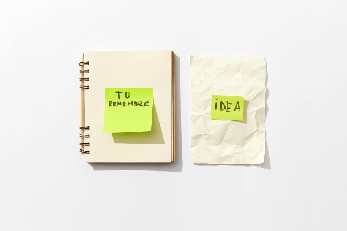 Notebook and sticky notes for content batching, representing the LinkedIn posting schedule workflow for solopreneurs