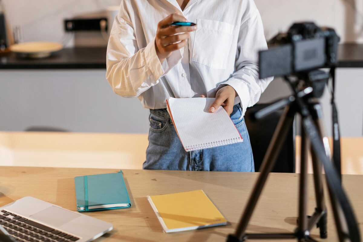 Content creator with camera, notes, and laptop — TikTok content strategy framework for reach, followers, and sales