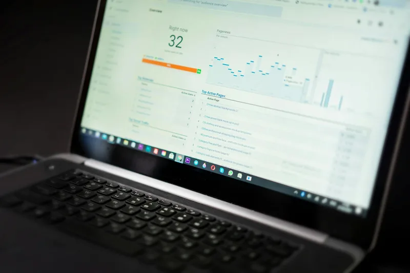 Laptop screen displaying YouTube Studio analytics dashboard showing channel performance metrics