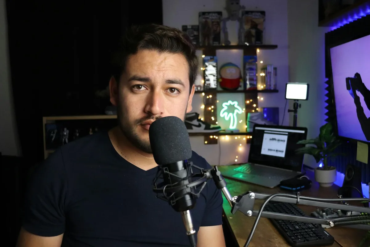 Solo creator planning YouTube content strategy at a desk with notebook and laptop