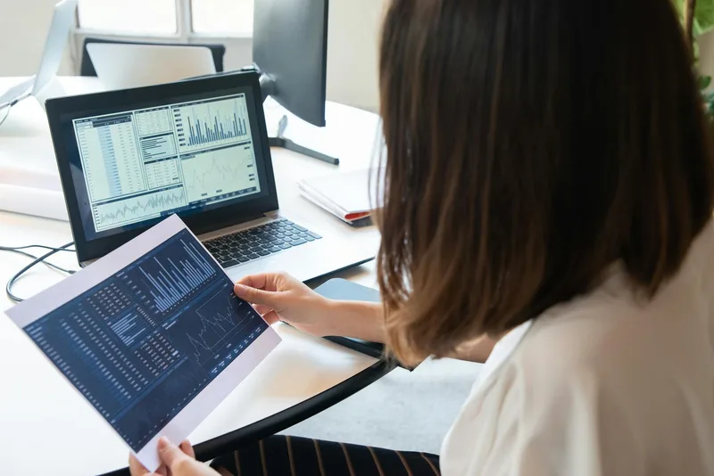 Person reviewing YouTube video analytics on a laptop, tracking which content drives leads and sales