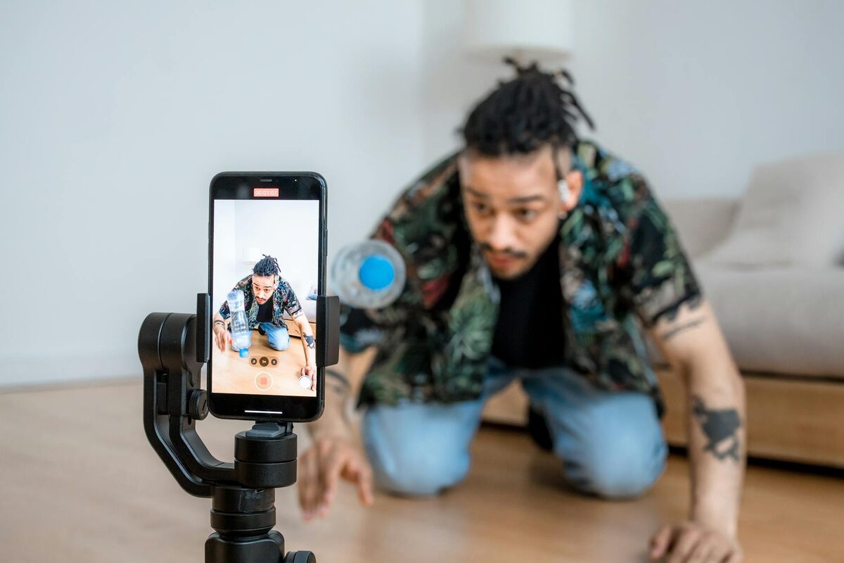 Man filming YouTube Shorts using a smartphone mounted on a gimbal, demonstrating a strong short-form video hook setup