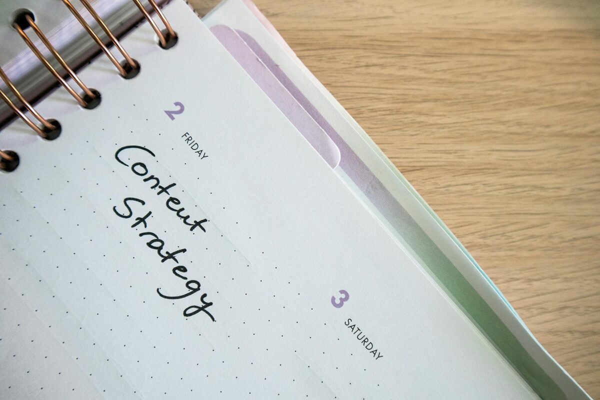 Content strategy notebook with handwritten plan for YouTube video ideas goals